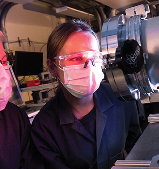 Le professeur Sylvain Coulombe et Lynn Hein examinent un système de plasma à basse pression